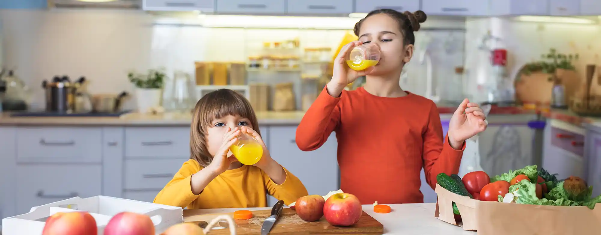 Children drink fresh organic orange juice