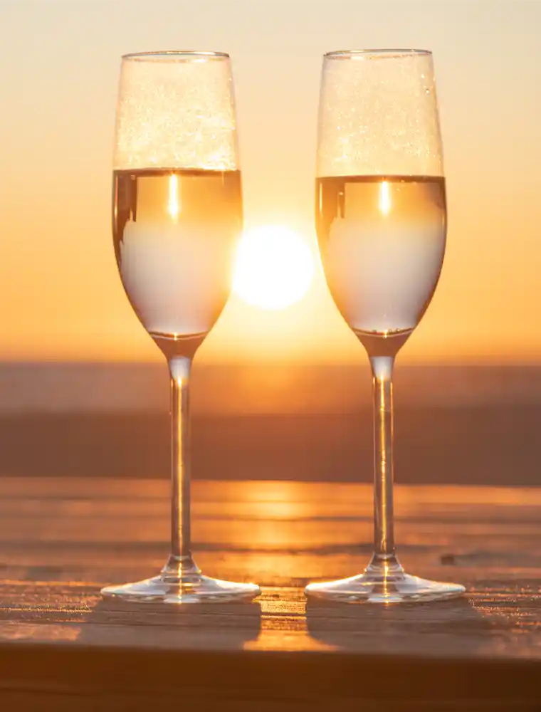 champagne glasses in sunset