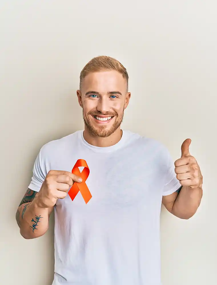 man smiling with orange ribbon